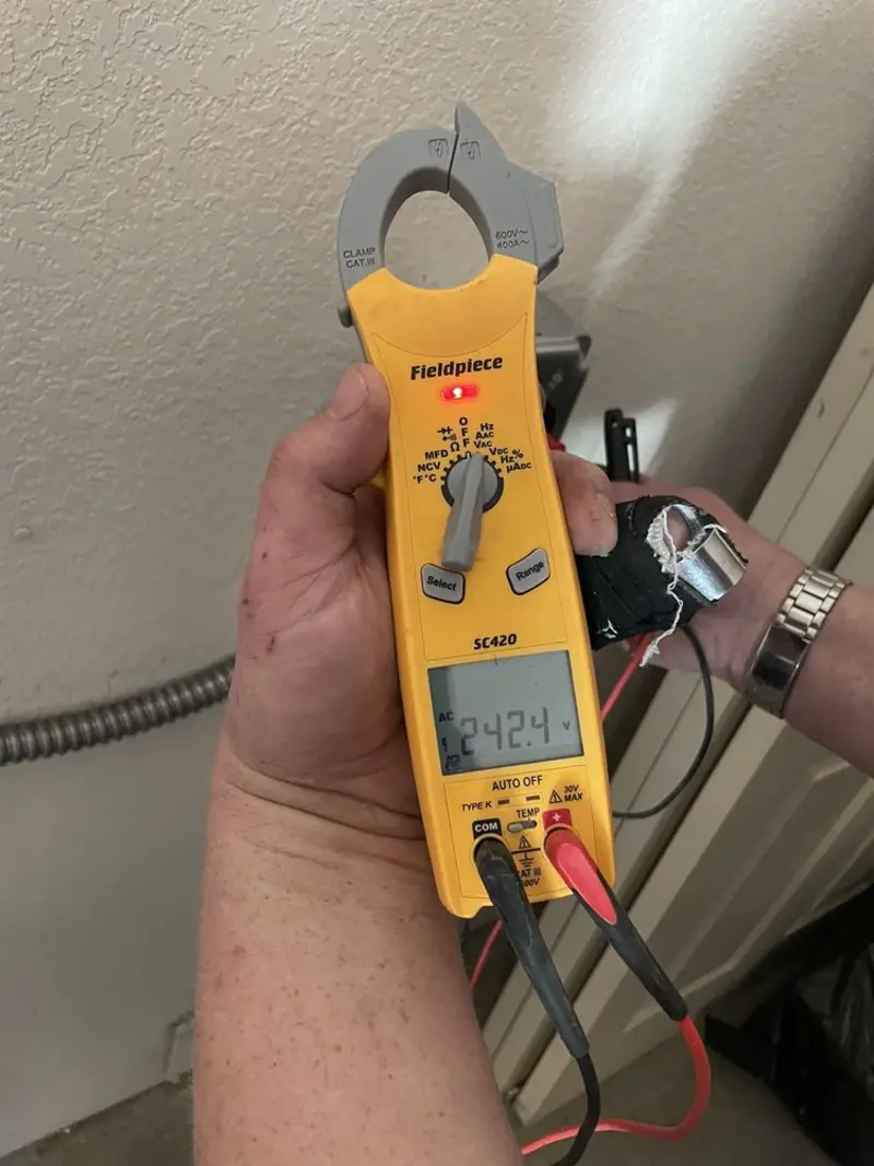 Voltage testing with clamp meter during Outlet Installation in Walker Mill
